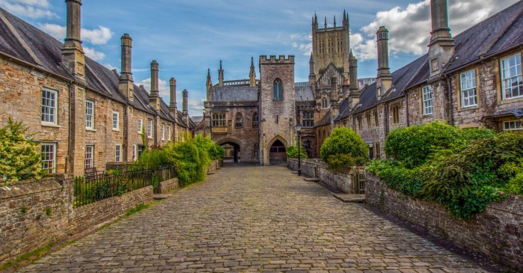 Things to do in Wells shown through Vicars' Close featuring medieval houses, a narrow stone street, and a peaceful historic atmosphere