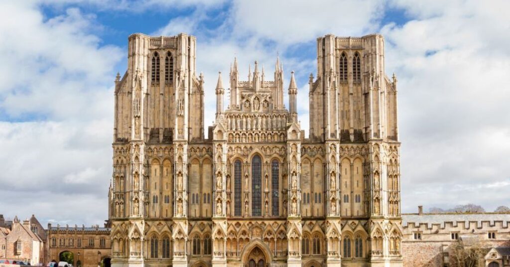 Things to do in Wells shown through Wells Cathedral featuring Gothic architecture, stone façade, open green space, and organized visitor areas
