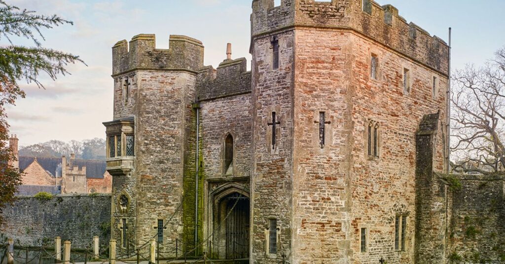 Things to do in Wells shown through Bishop’s Palace with historic buildings, landscaped gardens, stone walls, and peaceful walking areas