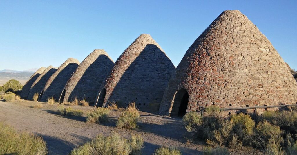 Things to do in McGill showing the stone Ward Charcoal Ovens set in the landscape near McGill Nevada